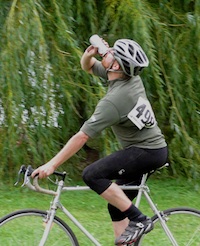 Man drinking beer on bike